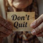 A woman holding the Don't Quit poem that saved Pat Falvey's during Ireland's recession