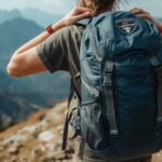 Hiker demonstrates how to pack for hiking with proper weight distribution and backpack adjustment on mountain trail