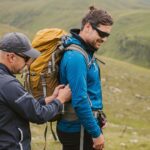 Fitting your backpack with professional guide on Irish mountain trail in Kerry