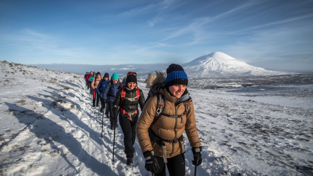 Winter hiking tips for joining guided group treks to develop skills on snow-covered mountain trails