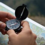 Using a compass on a topographic map during a mountain hike in Ireland