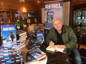 PAT FALVEY WITH HIS NEW BOOK. ACCIDENTAL REBEL