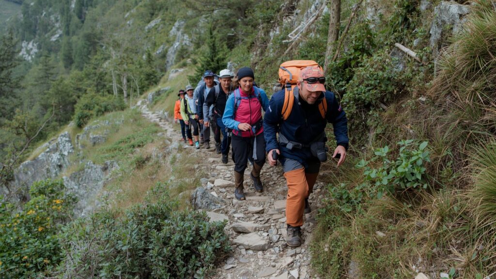 Guided mountain group taking decisive action toward achieving your goals by starting their climb with experienced leadership