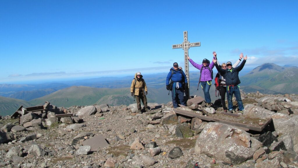 Climbers at Carrauntoohil summit cross, the highest of the Irish Munros at 1,039 metres in MacGillycuddy's Reeks