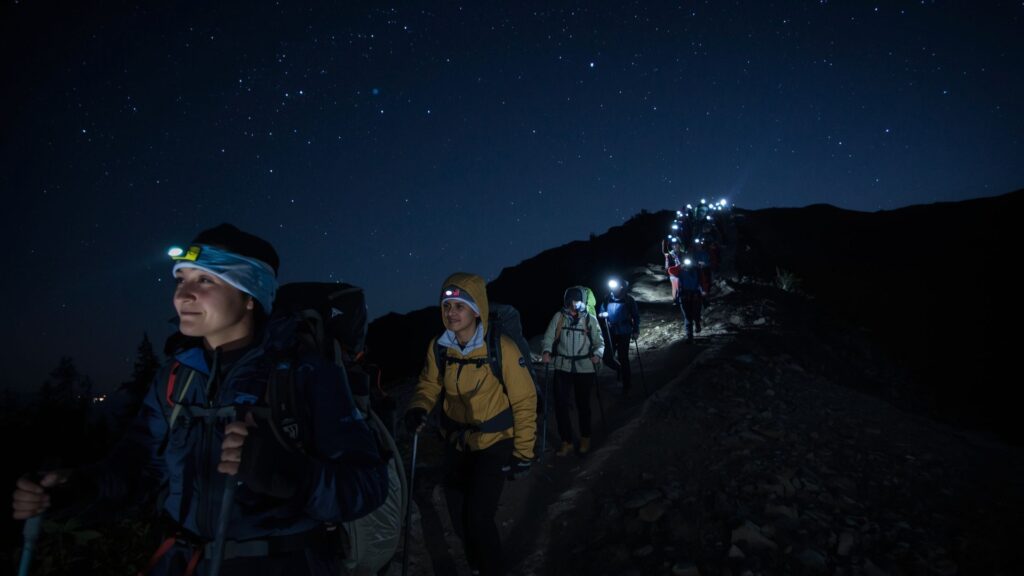 Trekker's guide to Kilimanjaro summit night climb showing hikers with headtorches ascending in darkness