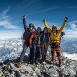 Pat Falvey leading 2025 Adventures expedition team on mountain summit with spectacular views